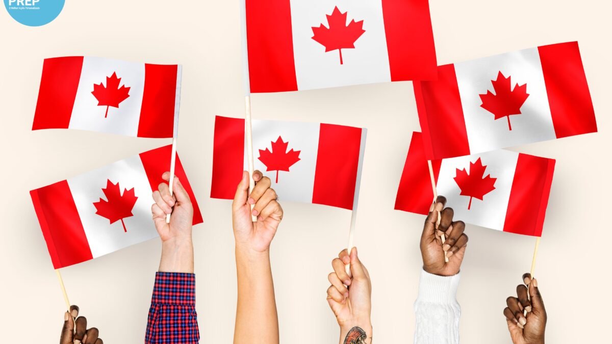 hands with canadian flags being held up by students who moved to canada after passing the IELTS test