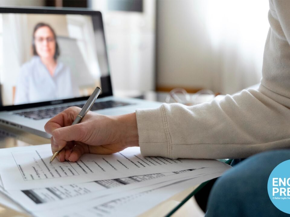 student having IELTS lessons with an instructor online and taking notes as she listens to instructions