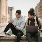 international students in canada who applied for a masters program sitting casually outside in casual clothing.